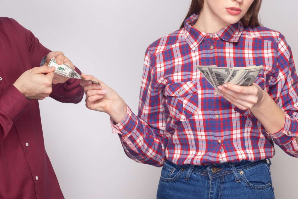 woman-handing-man-money-080725-11ee7b14ff314795903f1dd2510d0f61